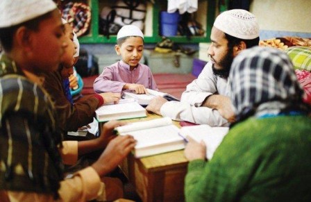 A qualifed teacher is teaching quran in traditional madrassa.